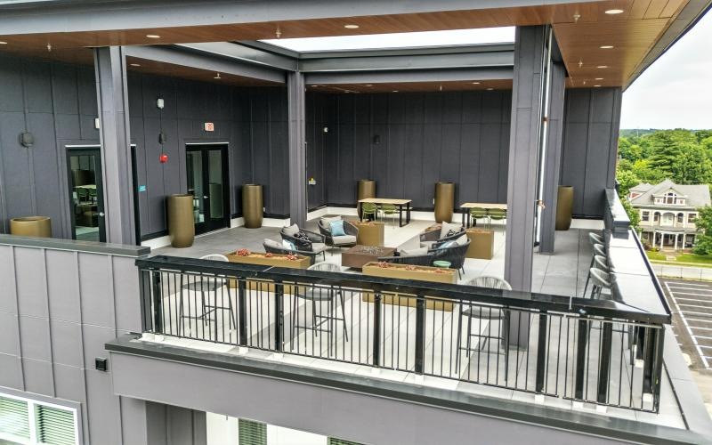 a patio with chairs and tables